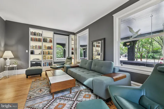 a large bed sitting in a bedroom next to a window