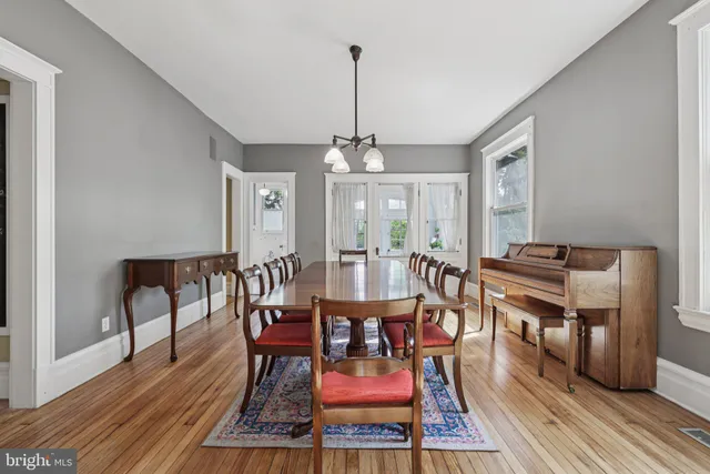 a kitchen that has a kitchen island wooden floor and a large window