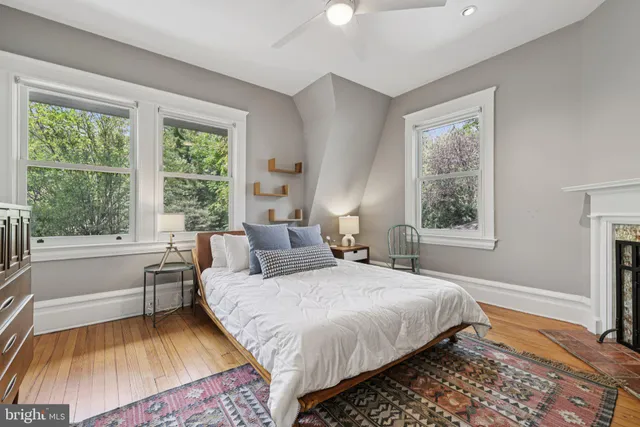 a view of a roof deck with couches and wooden floor