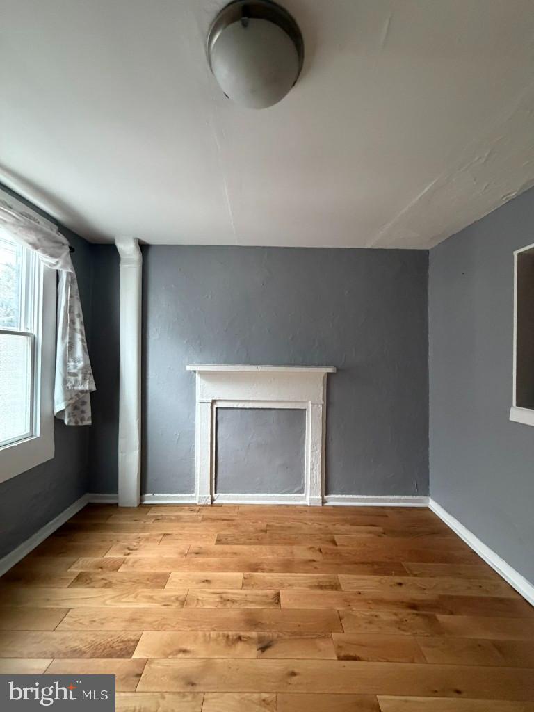 1607 Lemmon Street Baltimore, MD 21223 - Photo 3 of 30 a view of empty room with window and fireplace