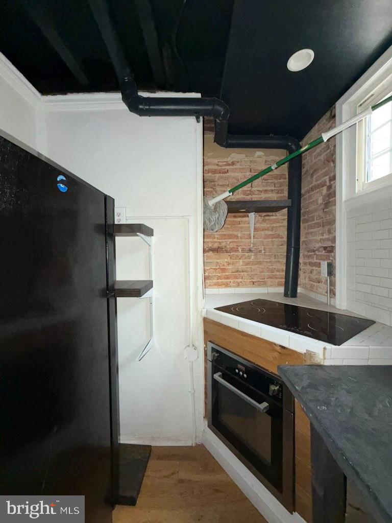 1607 Lemmon Street Baltimore, MD 21223 - Photo 8 of 30 a kitchen with stainless steel appliances granite countertop a refrigerator and a stove