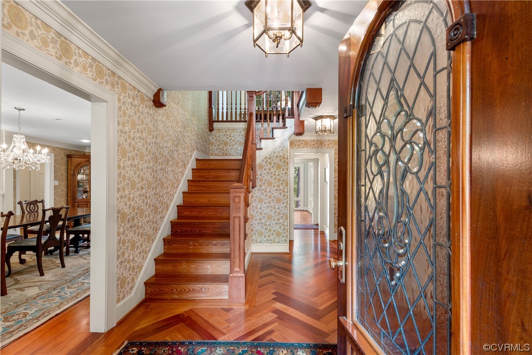 10320 Cherokee Road Richmond, VA 23235 - Photo 7 of 49 a view of staircase with lots of frames on wall and a chandelier