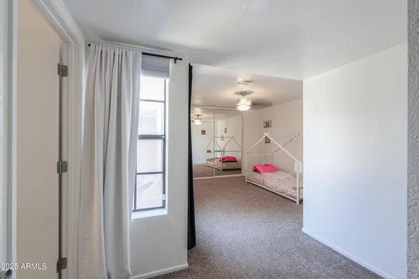 a view of a room with walk in closet and wooden floor