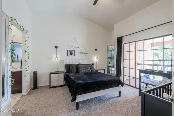a bedroom with a bed and a large window
