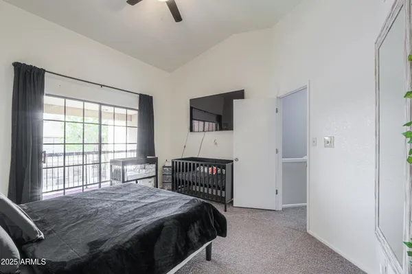 a bedroom with a bed and a flat screen tv