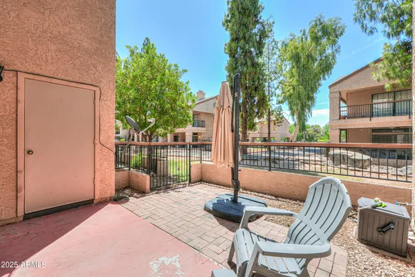 a view of balcony with two chairs and a potted plant