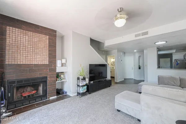 a living room with furniture and a fireplace