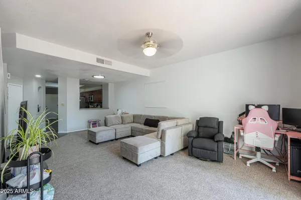 a living room with furniture and a chandelier