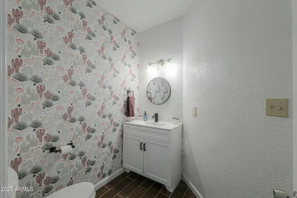 a bathroom with a sink a toilet and mirror