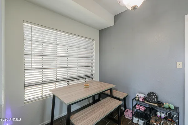 a view of a workspace with furniture and a window