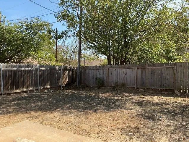 a view of outdoor space with wooden fence