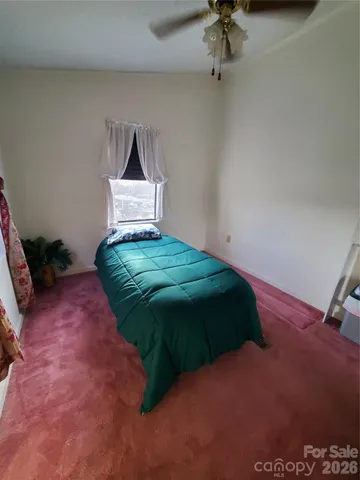 a bedroom with a bed and window