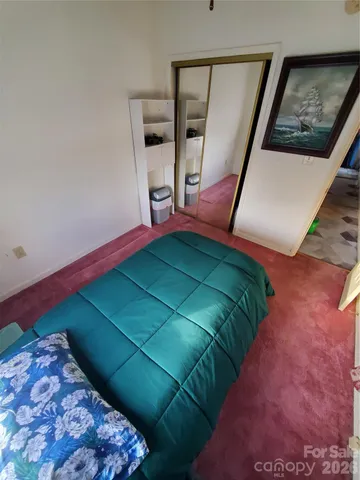 a bed sitting in a bedroom next to a window