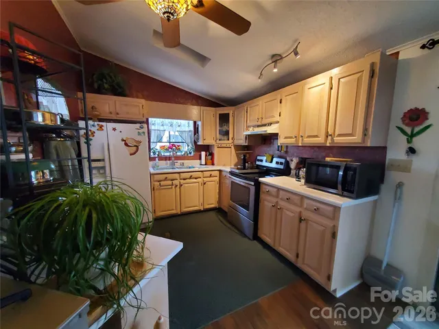 a kitchen with a sink window and cabinets