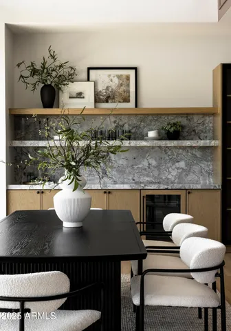 a kitchen with a table chairs and refrigerator
