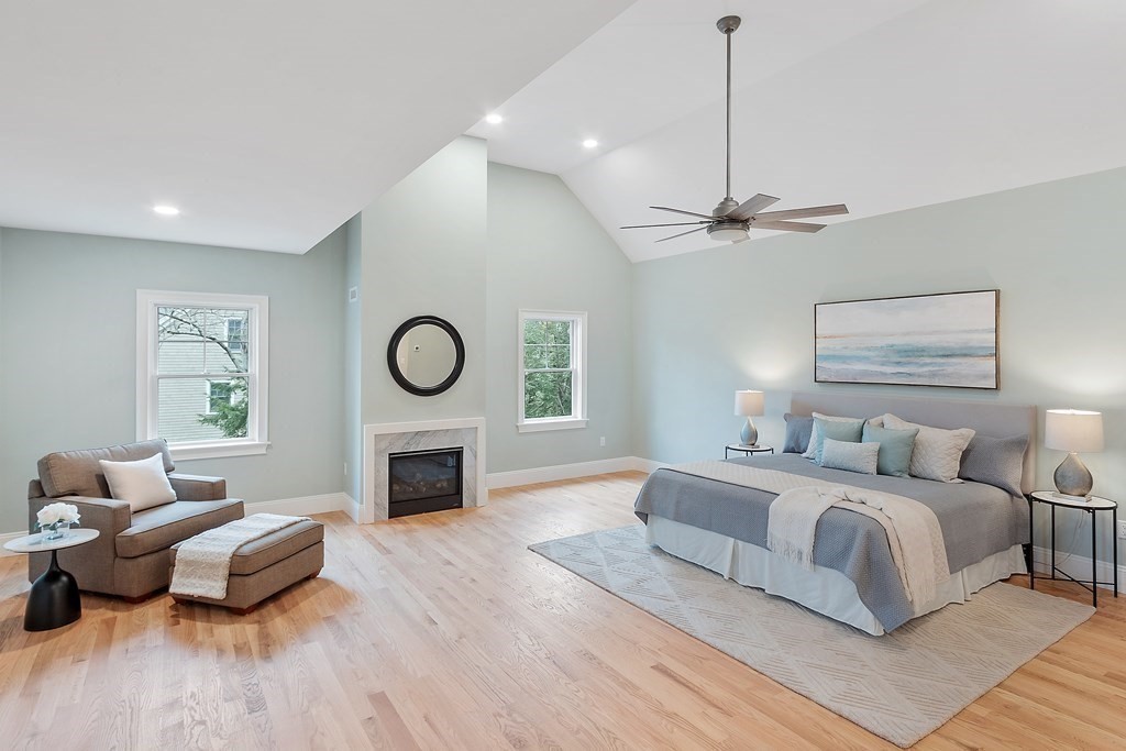 4 Mill Brook Road Lexington, MA 02420 - Photo 21 of 42 a bedroom with a bed couches and a fireplace