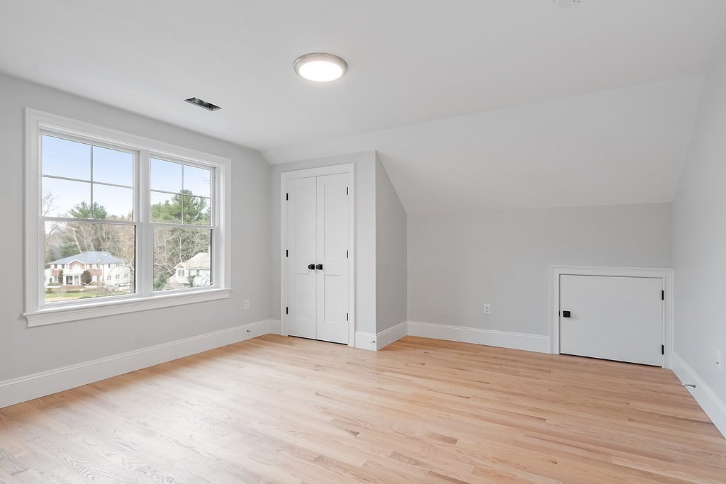 4 Mill Brook Road Lexington, MA 02420 - Photo 32 of 42 an empty room with wooden floor and windows