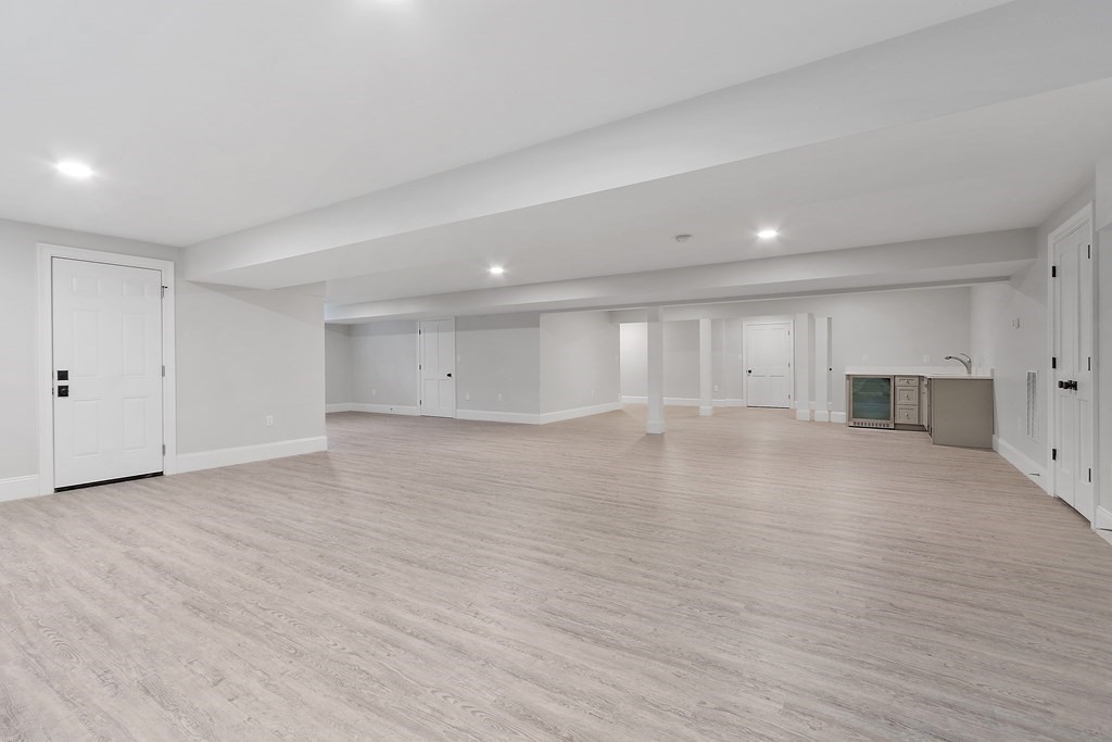 4 Mill Brook Road Lexington, MA 02420 - Photo 34 of 42 a view of empty room with wooden floor and kitchen