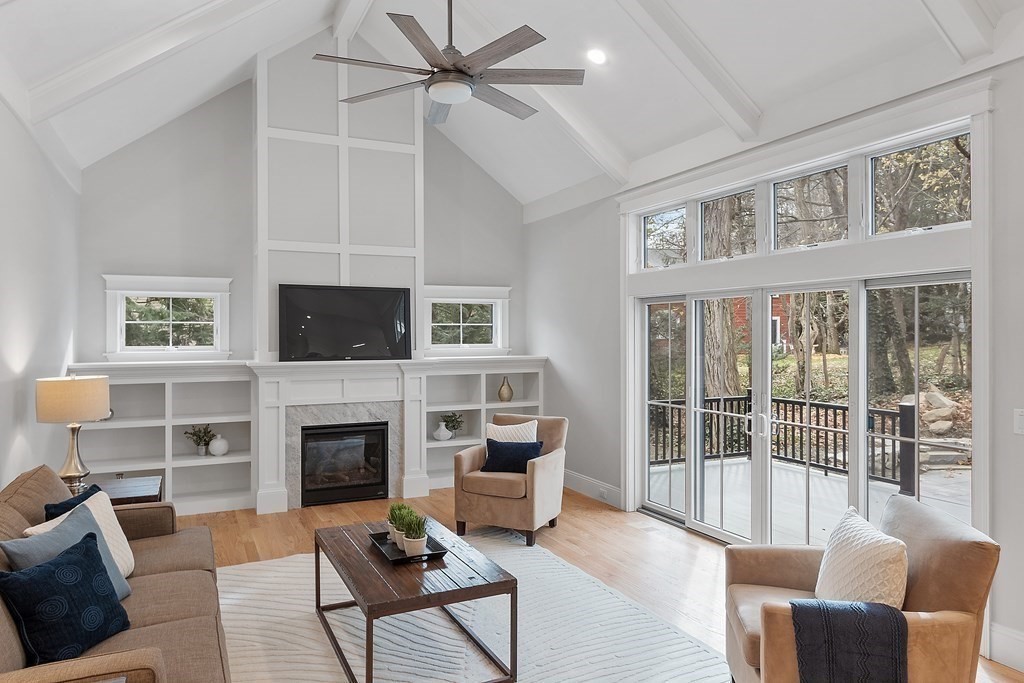 4 Mill Brook Road Lexington, MA 02420 - Photo 9 of 42 a living room with furniture a flat screen tv and a fireplace