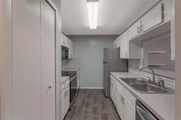 a kitchen with a sink and refrigerator