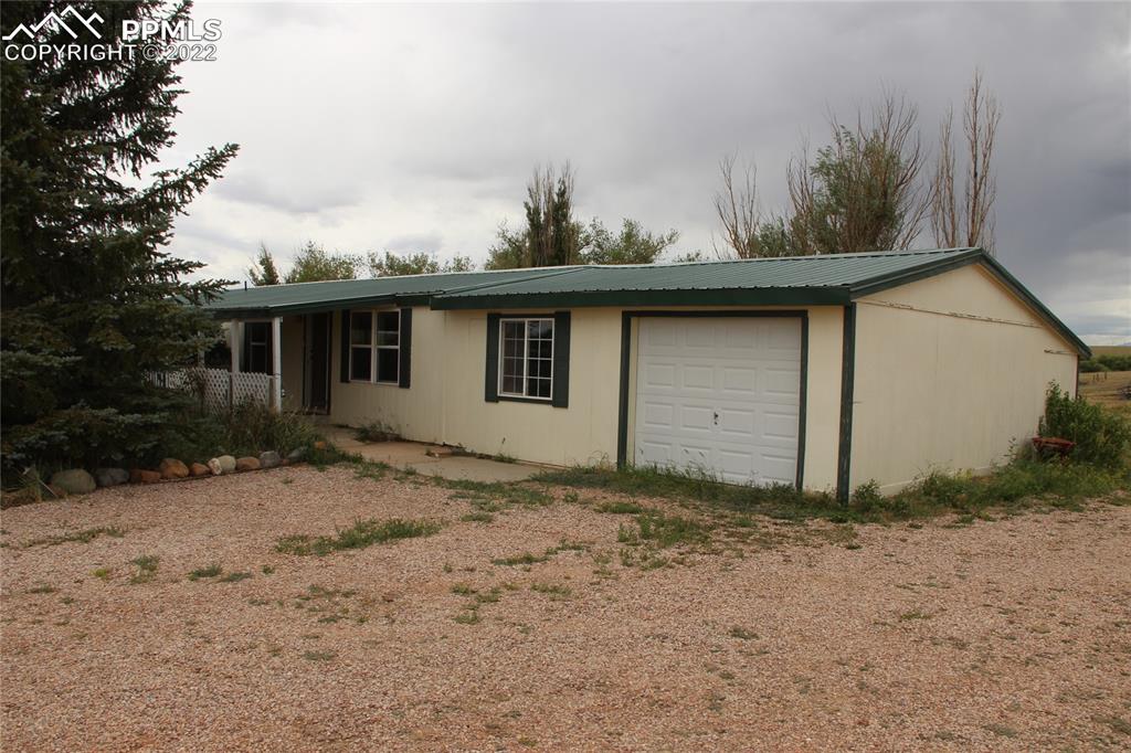 11905 Paint Mine Road Calhan, CO 80808 - Photo 1 of 35 a view of a house with a yard