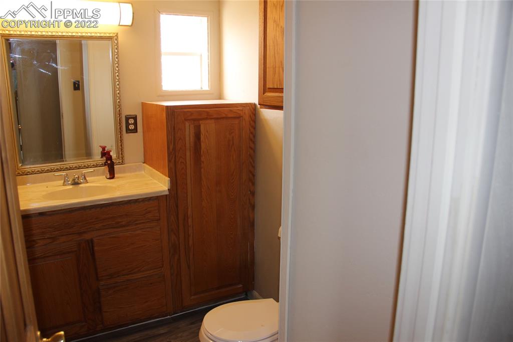11905 Paint Mine Road Calhan, CO 80808 - Photo 18 of 35 a bathroom with a sink vanity mirror and toilet