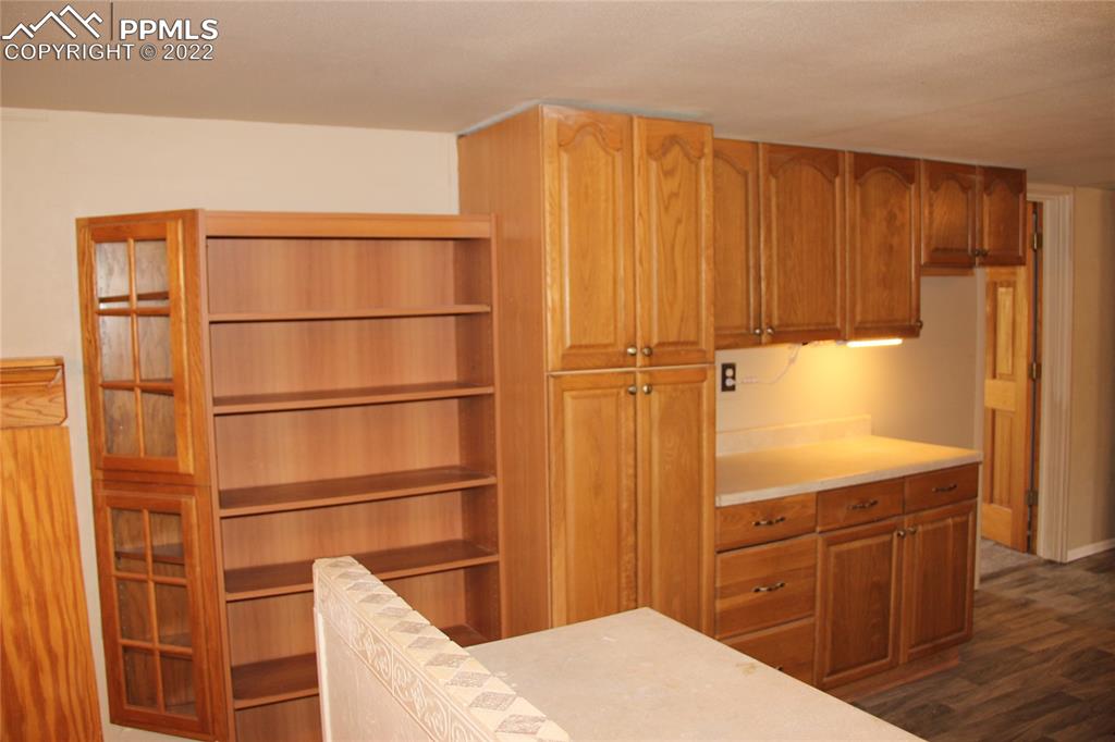 11905 Paint Mine Road Calhan, CO 80808 - Photo 5 of 35 a kitchen with a refrigerator and cabinets