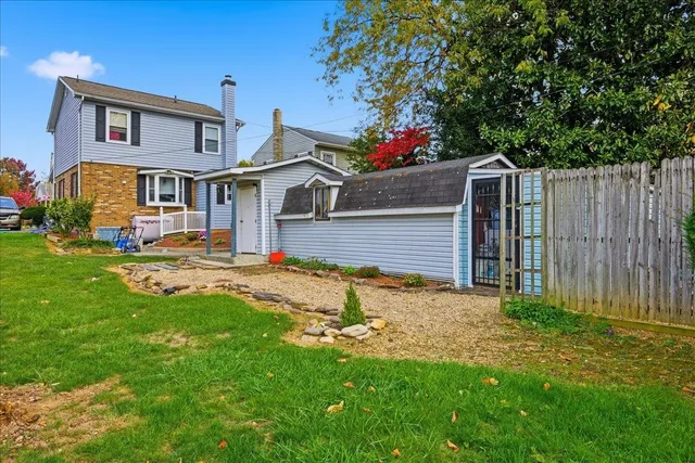 a view of swimming pool with outdoor seating and a garden