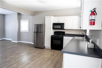 344 Bushkill Street, Unit 2 Easton, PA 18042 - Photo 25 of 30 A well-appointed kitchen featuring a gas range and sleek countertops, seamlessly connects to a spacious living area.