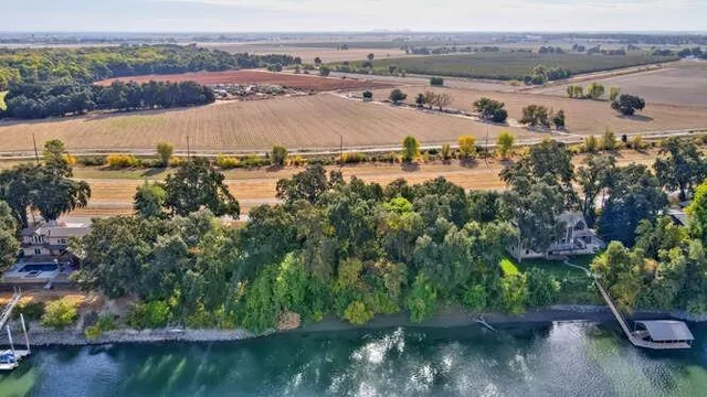 an aerial view of beach and residential houses with outdoor space