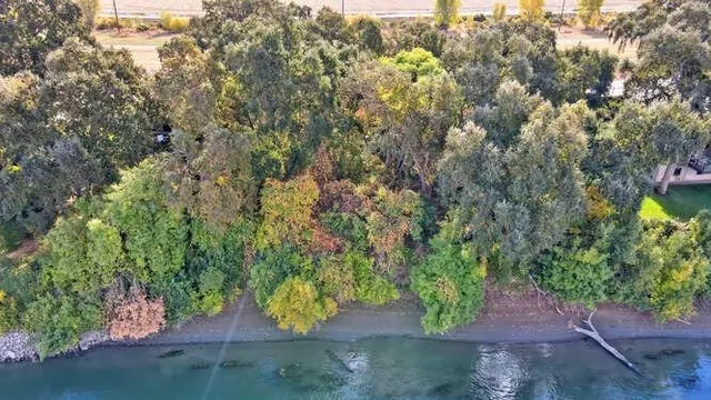 an aerial view of residential building with outdoor space and lake view