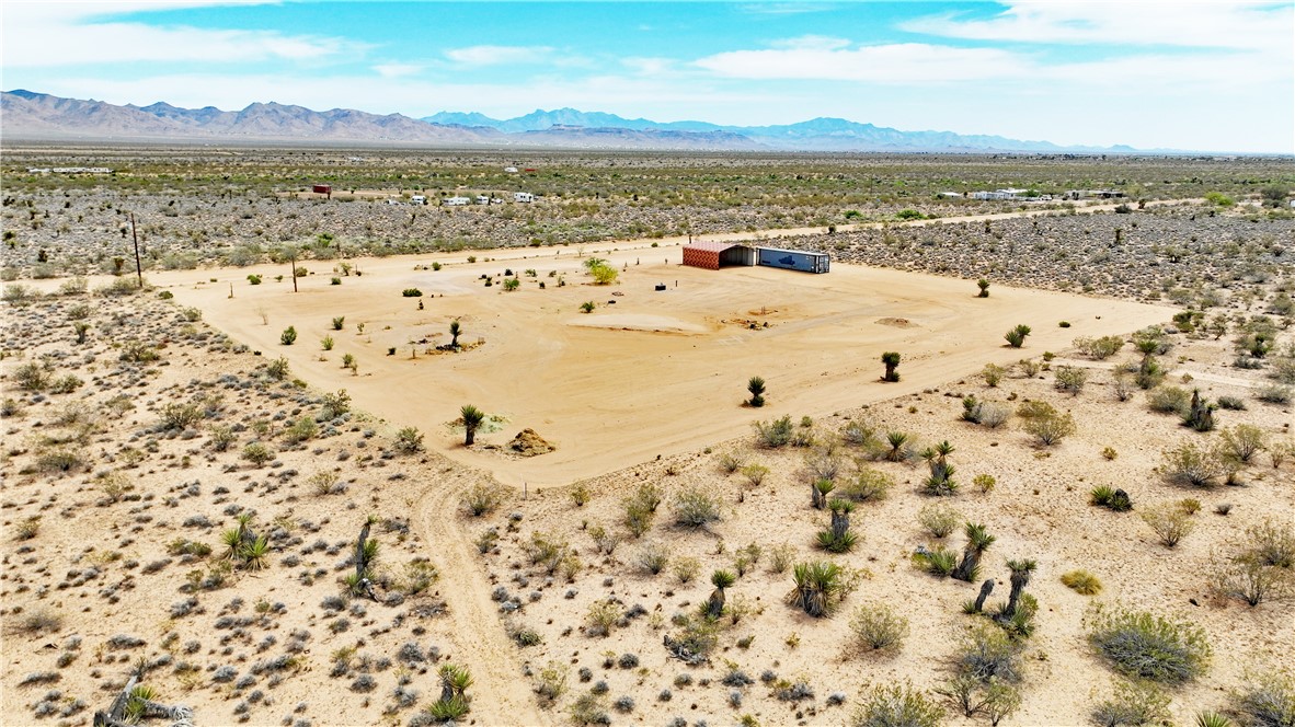 5649 Davis Road Golden Valley, AZ 86413 - Photo 11 of 24 Expansive desert lot featuring a cleared building pad and distant mountain ranges