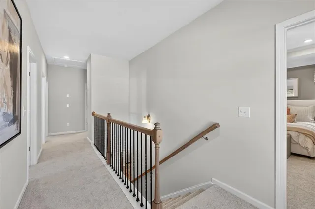 a view of a hallway with entryway and stairs