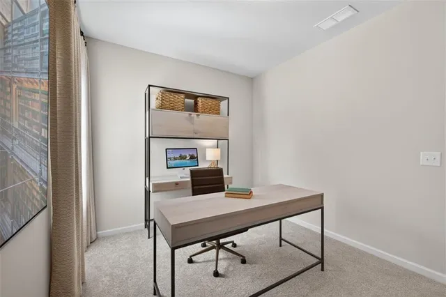 a view of a workspace with furniture