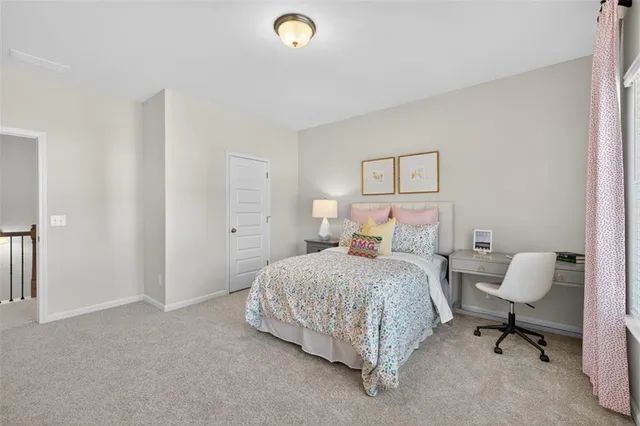 a bedroom with a bed and a chair