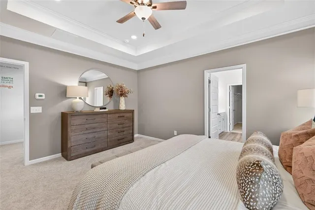 a bedroom with a bed a chandelier and a dresser