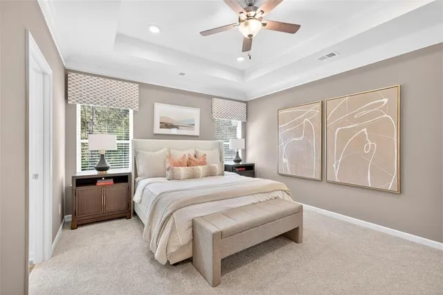 a spacious bedroom with a large bed and a chandelier