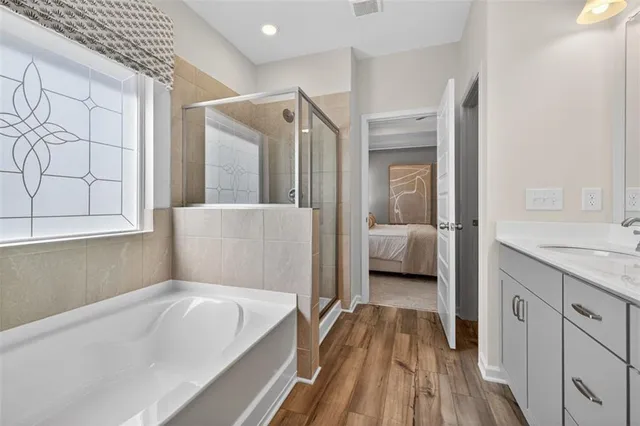 a en suite bathroom with a tub shower and sink