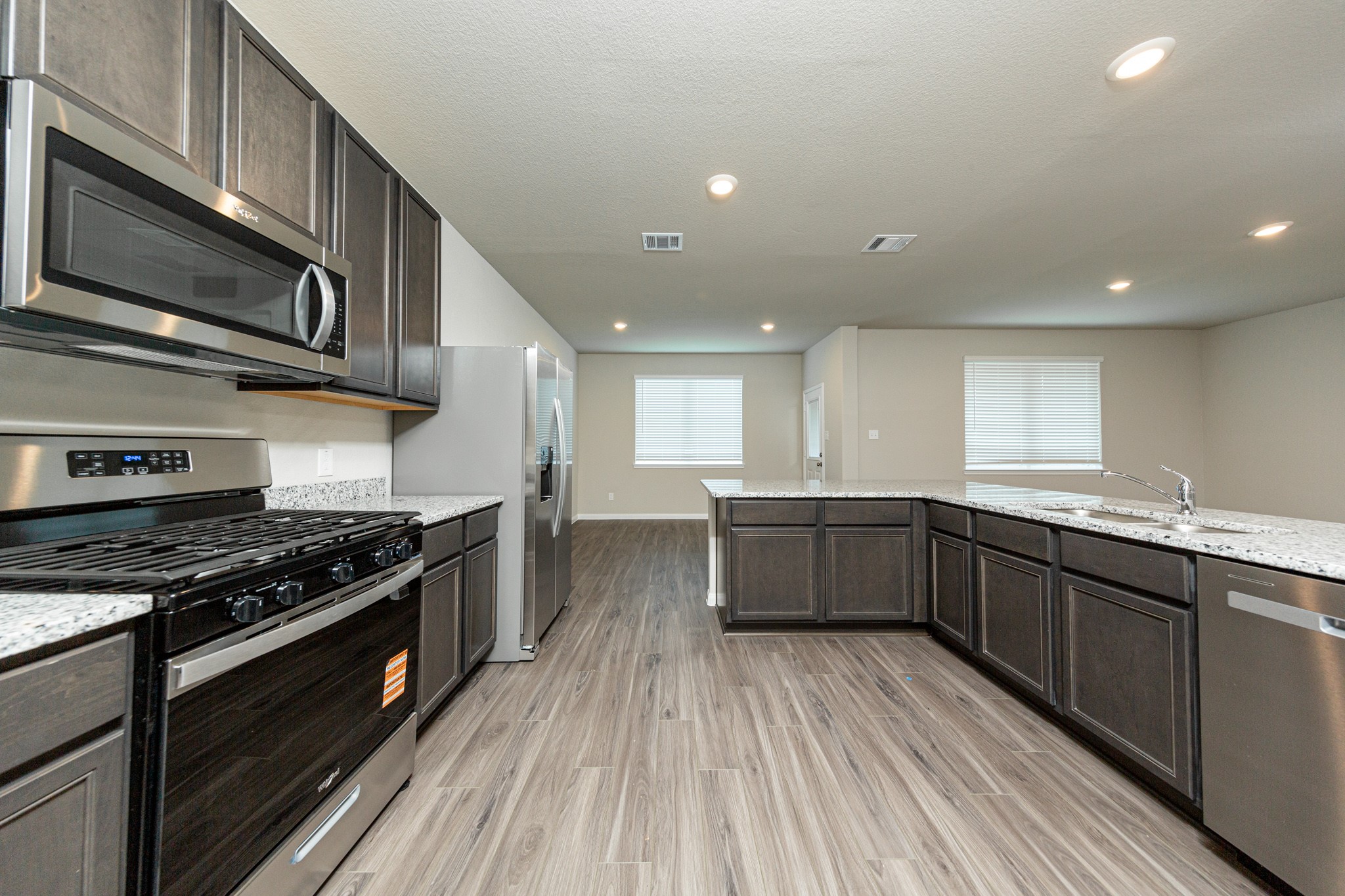 13663 Kit Run Splendora, TX 77372 - Photo 8 of 28 a kitchen with stainless steel appliances a stove sink and cabinets