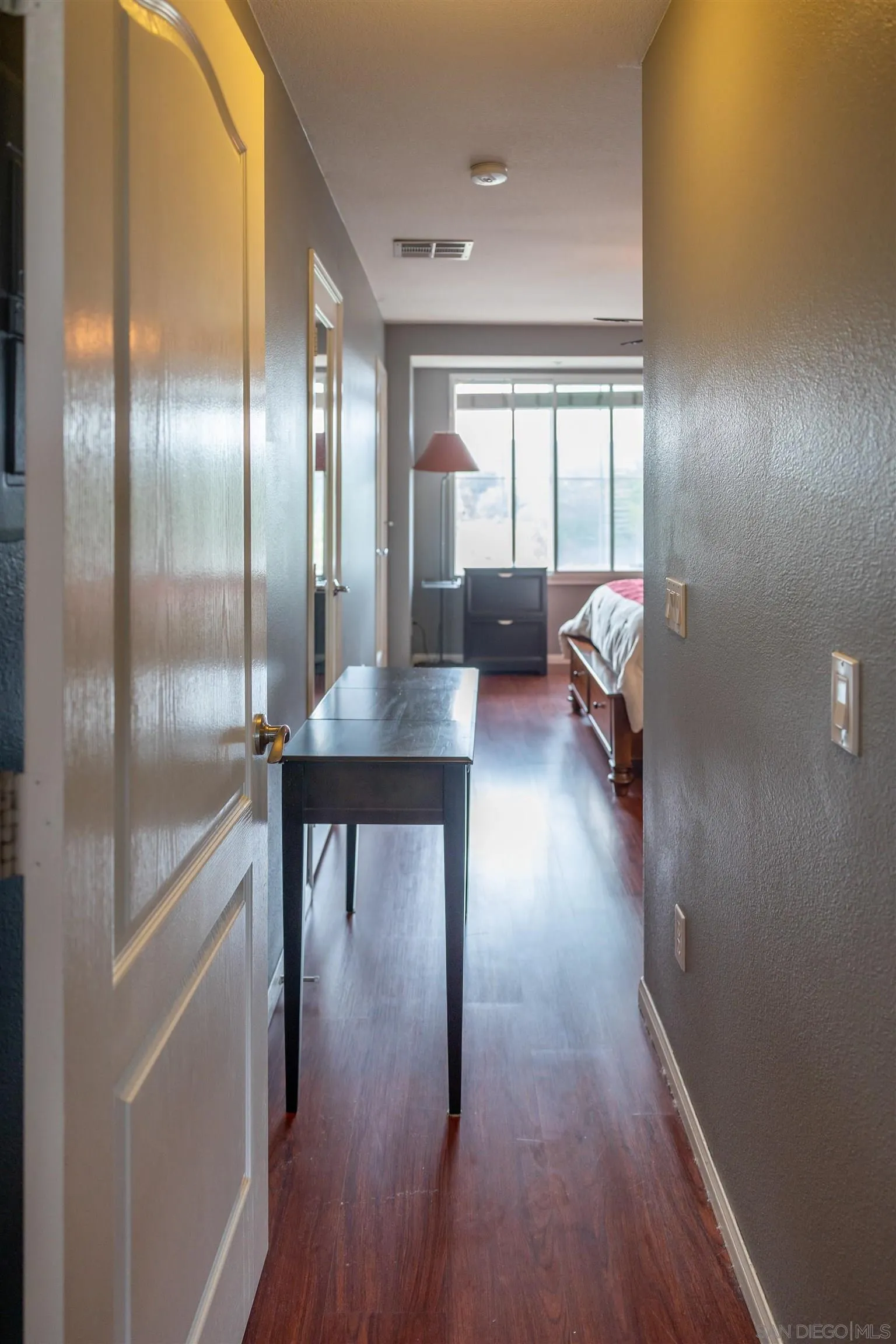 30 Via Sovana Santee, CA 92071 - Photo 13 of 23 a hallway with a wooden floor and a table