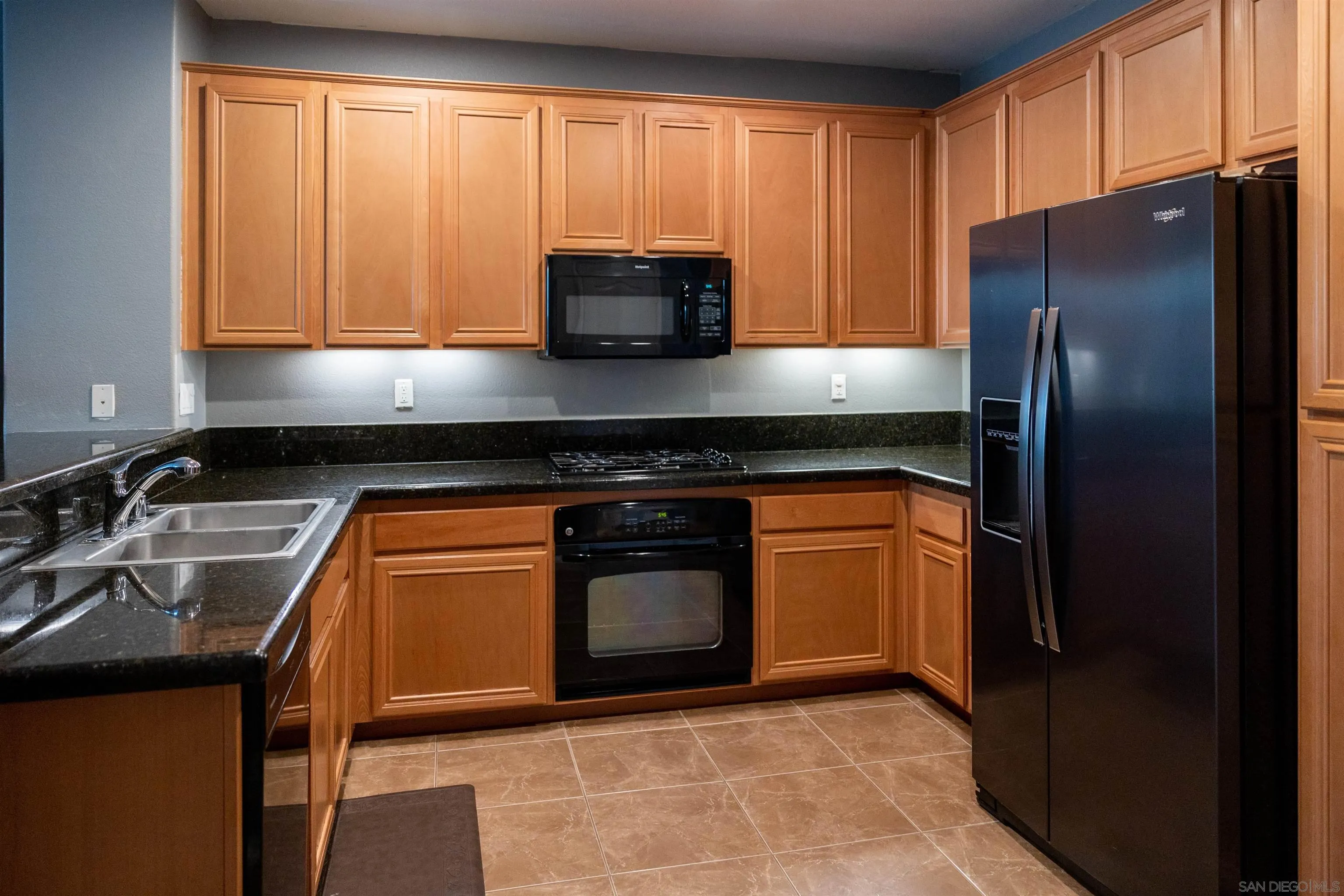 30 Via Sovana Santee, CA 92071 - Photo 2 of 23 a kitchen with granite countertop a refrigerator stove and microwave