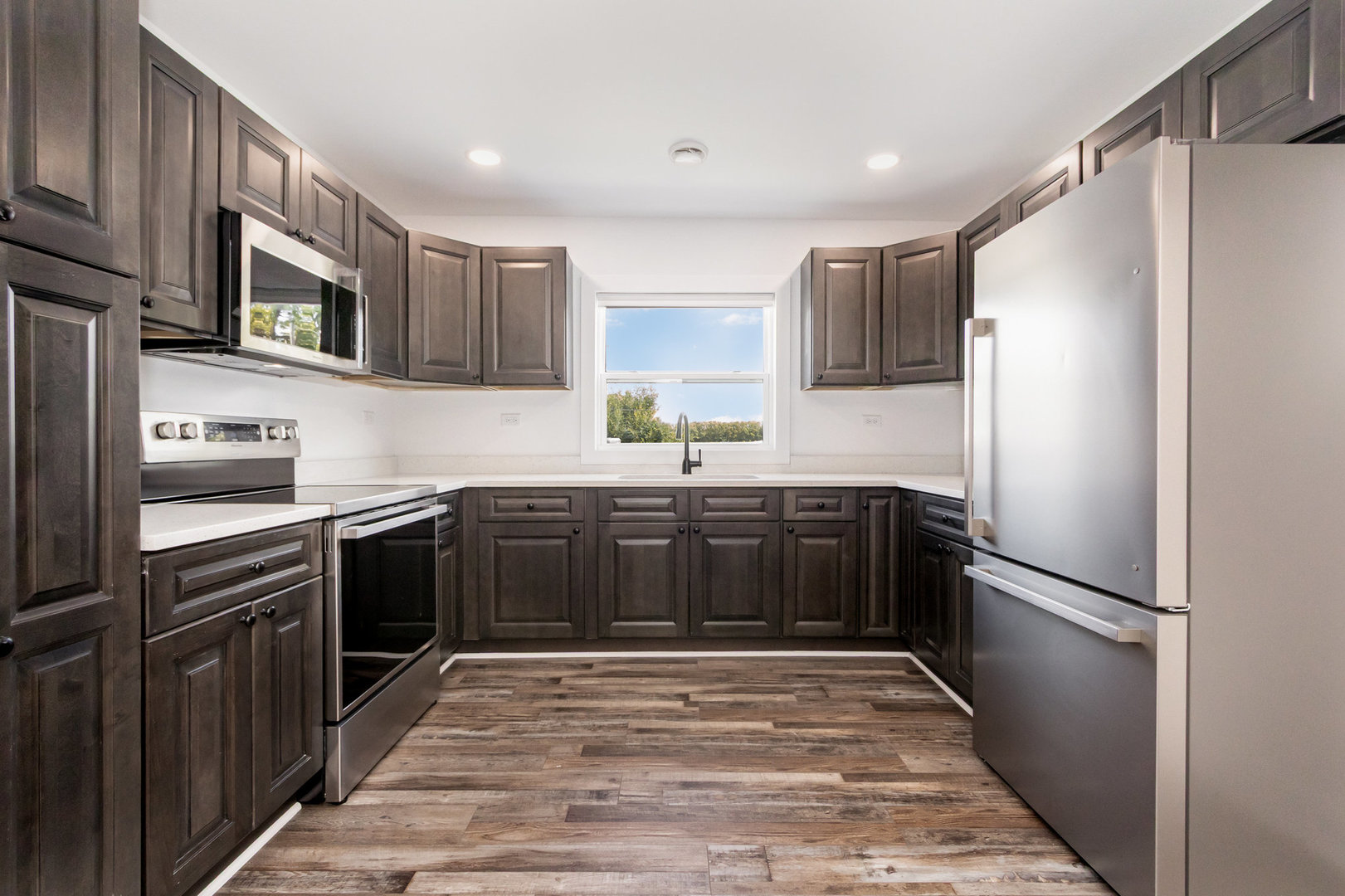 25365 South Fryer Street, Unit 1 Channahon, IL 60410 - Photo 5 of 15 a kitchen with a refrigerator and a sink
