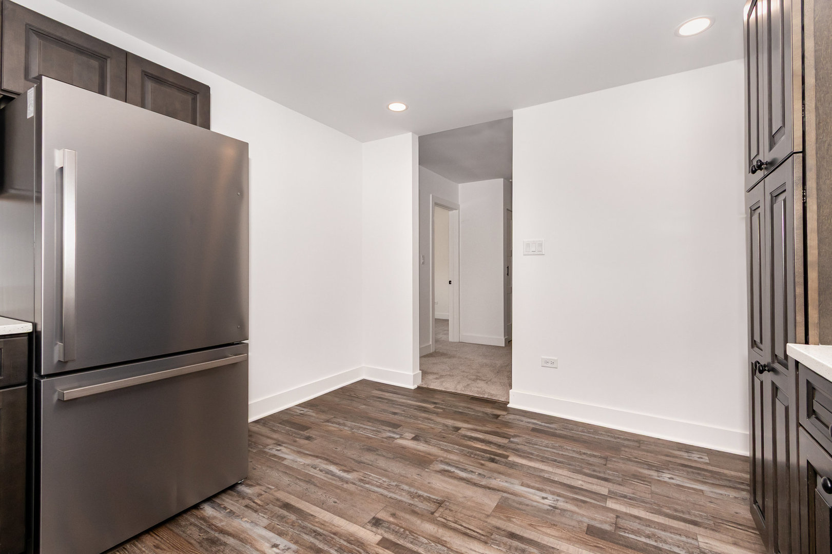 25365 South Fryer Street, Unit 1 Channahon, IL 60410 - Photo 6 of 15 a view of a refrigerator in kitchen and wooden floor