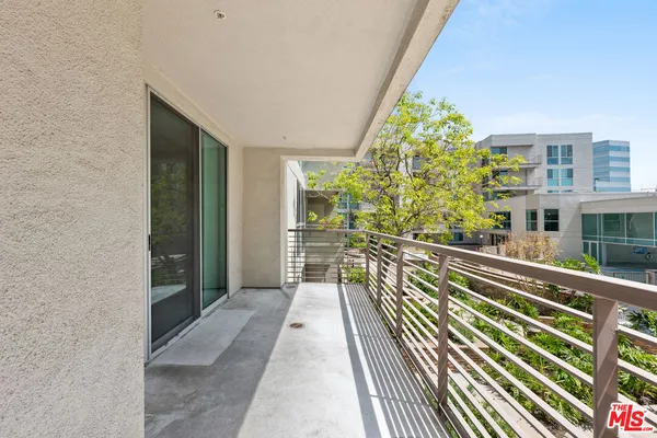 a view of balcony with wooden floor