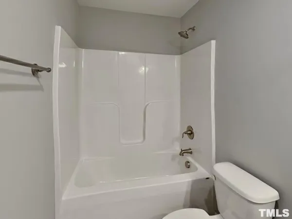 a bathroom with a toilet and a bathtub
