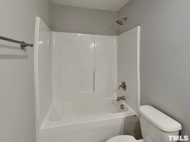 a bathroom with a toilet and a bathtub