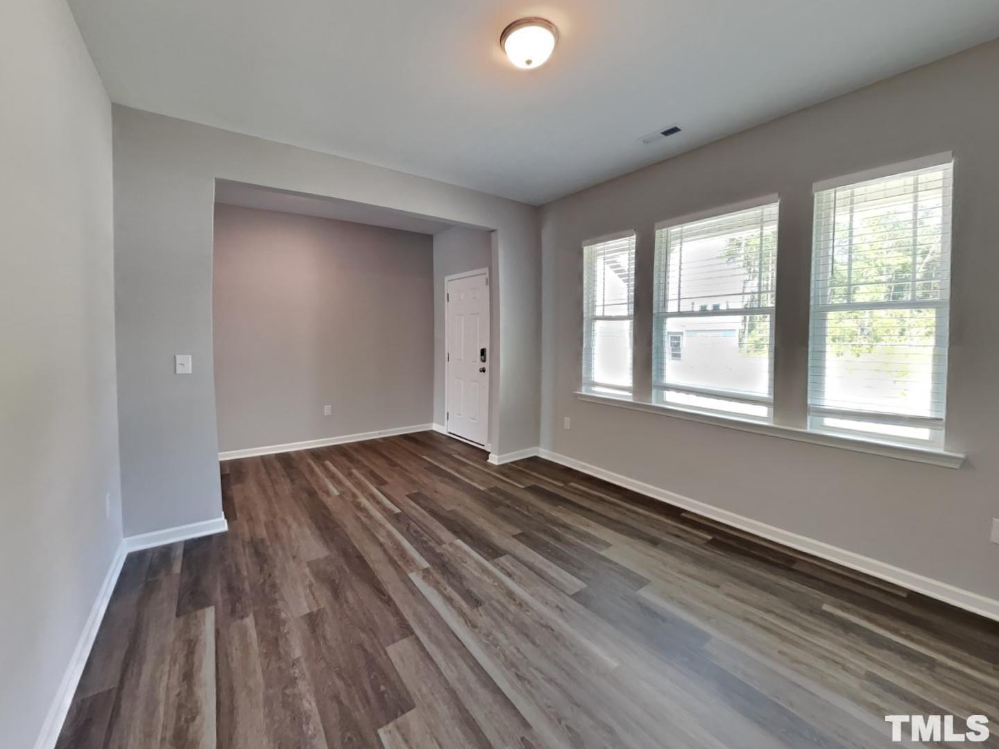 295 Avery Meadows Drive Smithfield, NC 27577 - Photo 4 of 15 a view of empty room with wooden floor and fan