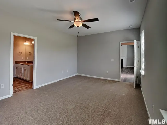 a view of a livingroom with a ceiling fan and wooden floor