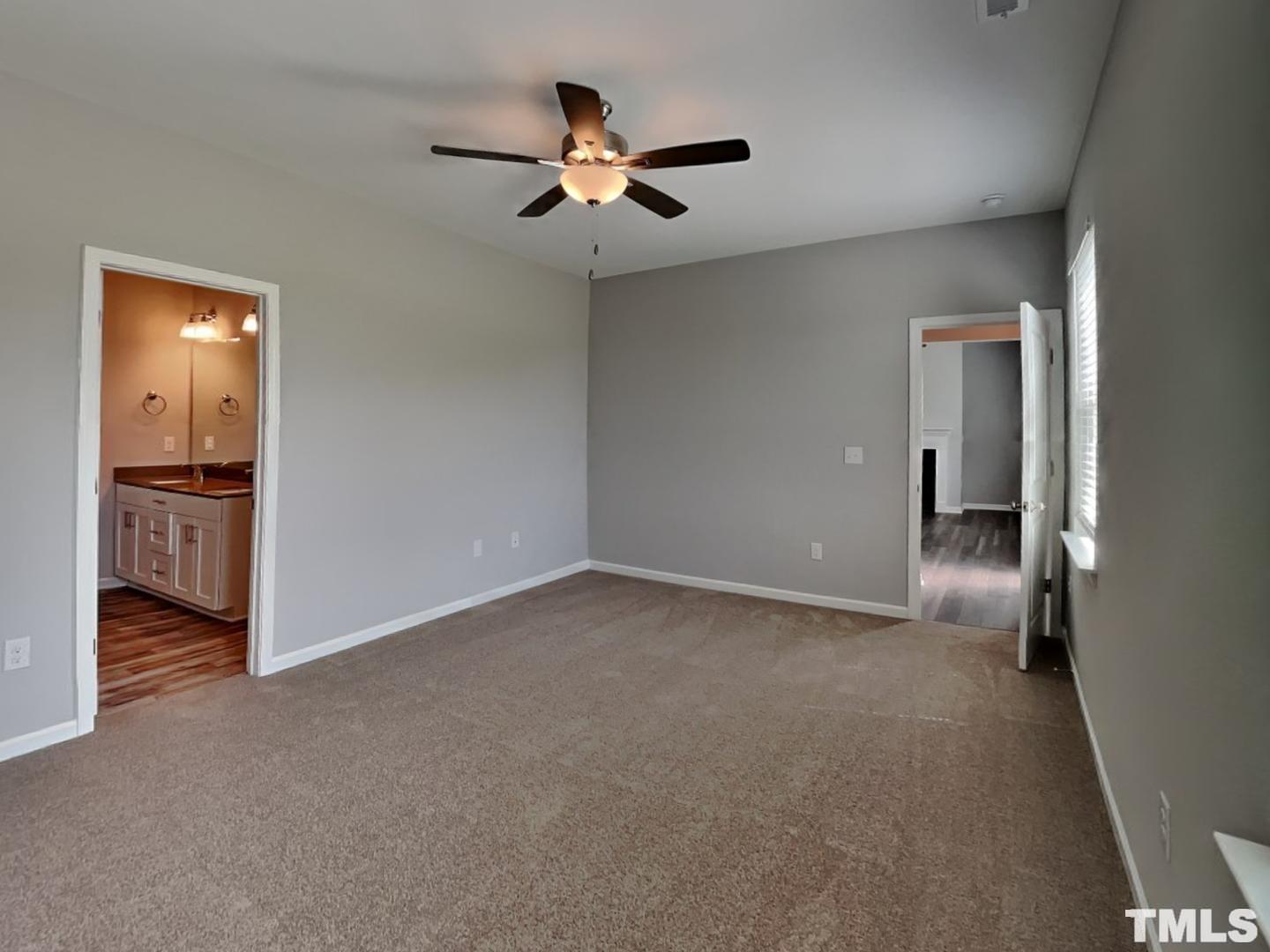 295 Avery Meadows Drive Smithfield, NC 27577 - Photo 6 of 15 a view of a livingroom with a ceiling fan and wooden floor