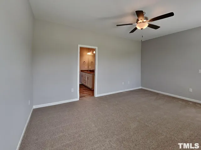 a view of empty room with ceiling fan